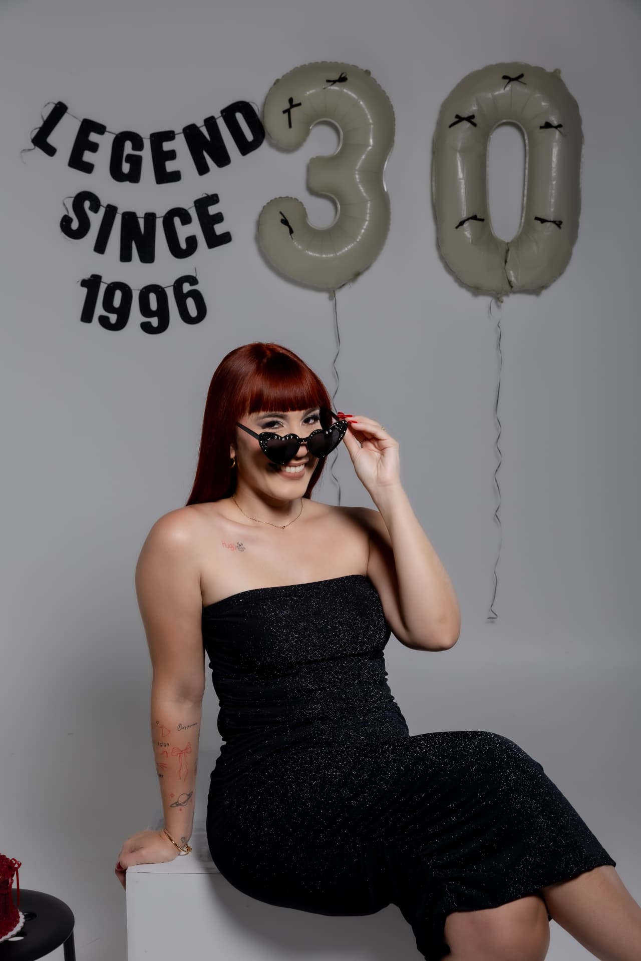 Mujer con vestido negro brillante celebrando cumpleaños