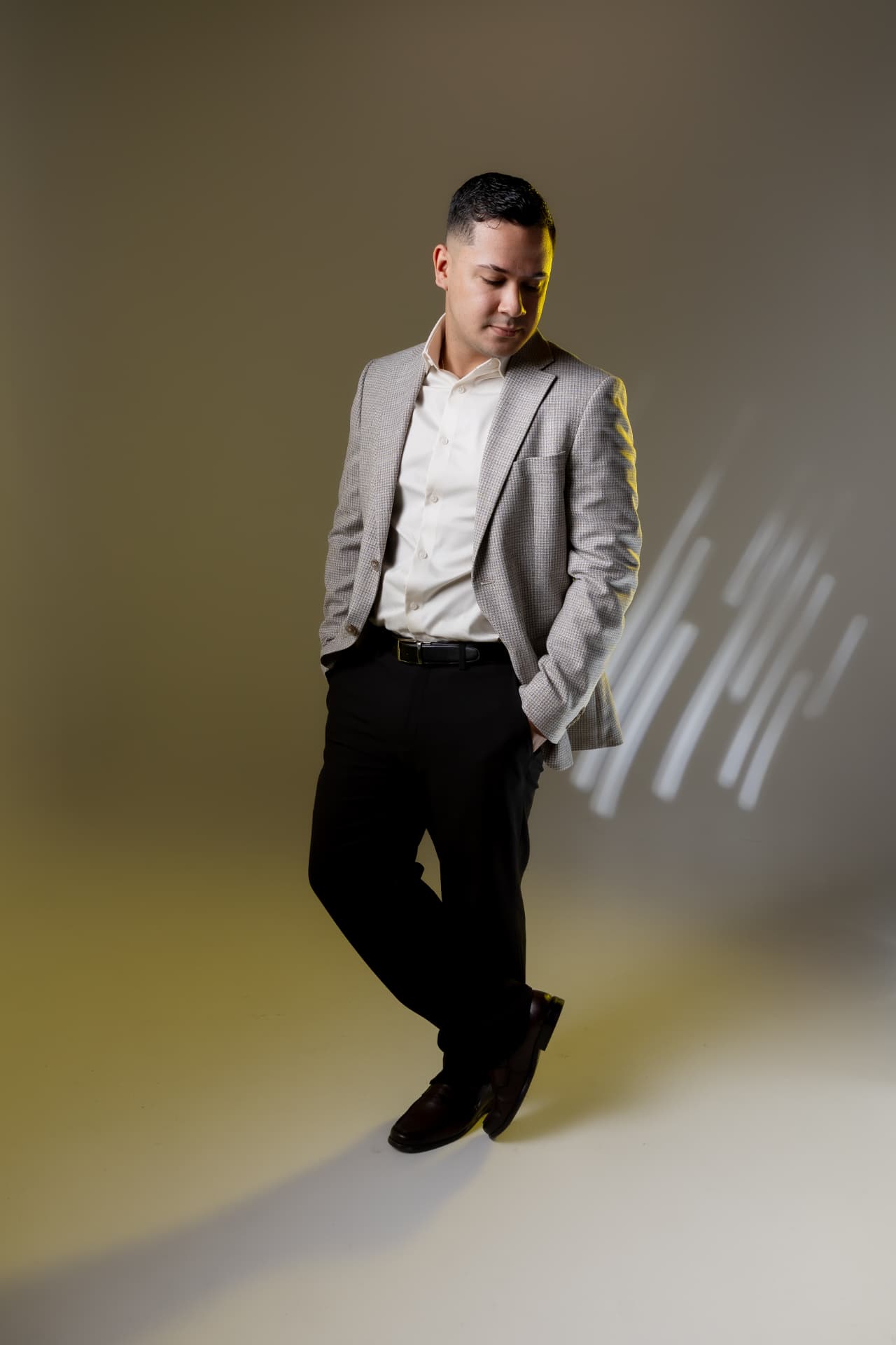 Retrato profesional de hombre con blazer gris y camisa blanca