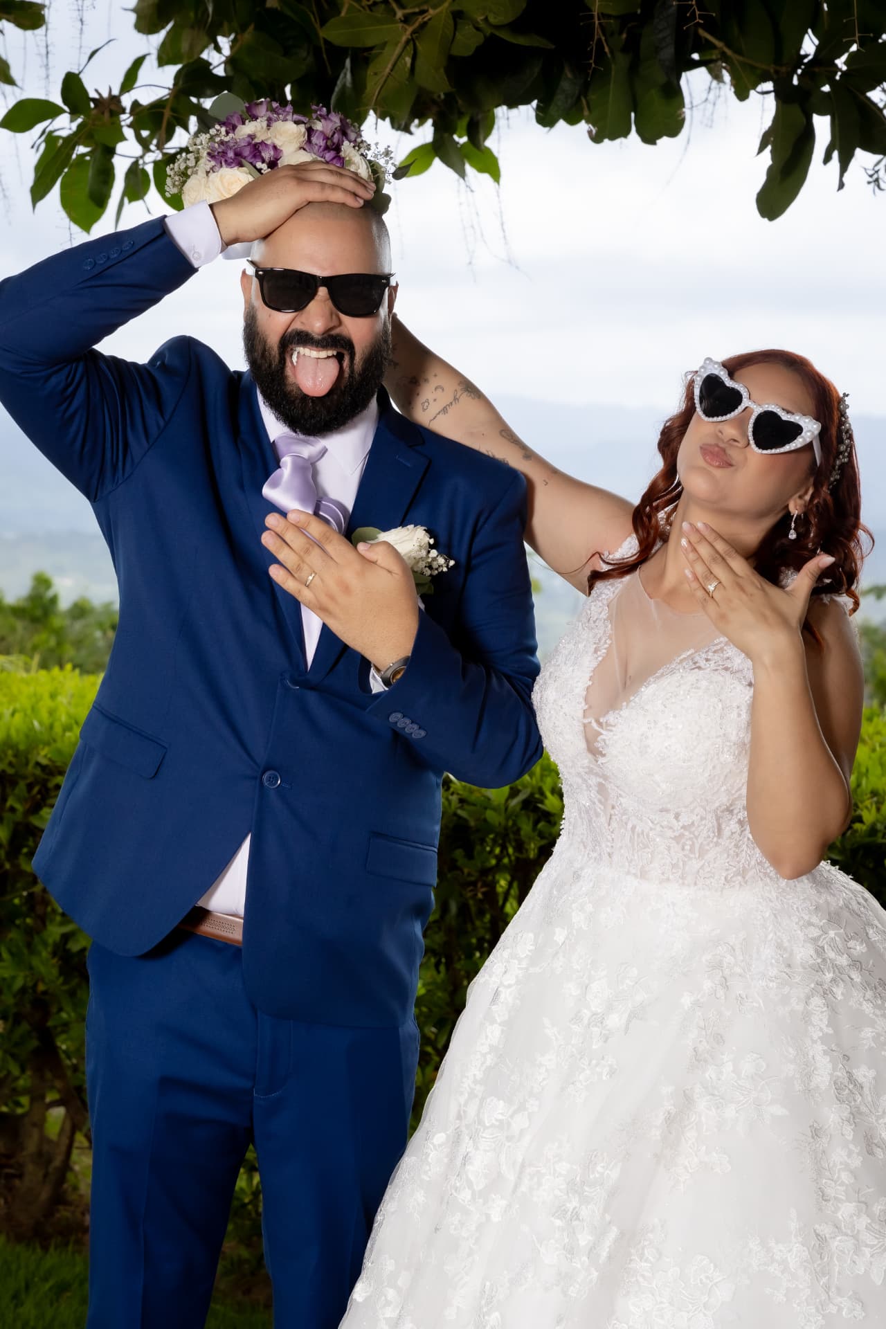 Novios divertidos con lentes de sol en sesión al aire libre