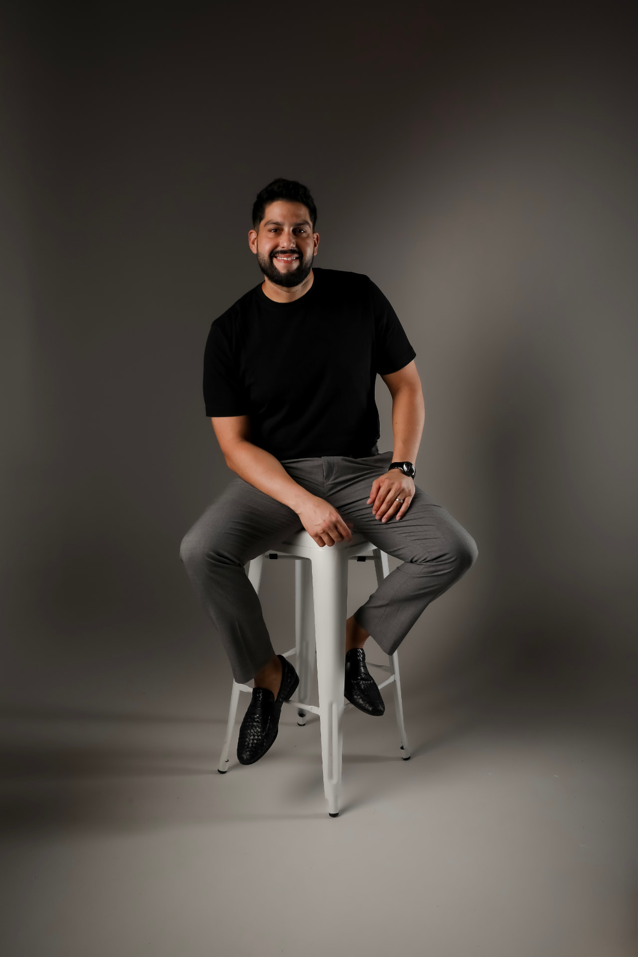 Retrato del fotógrafo Ricardo Alicea sentado en una silla